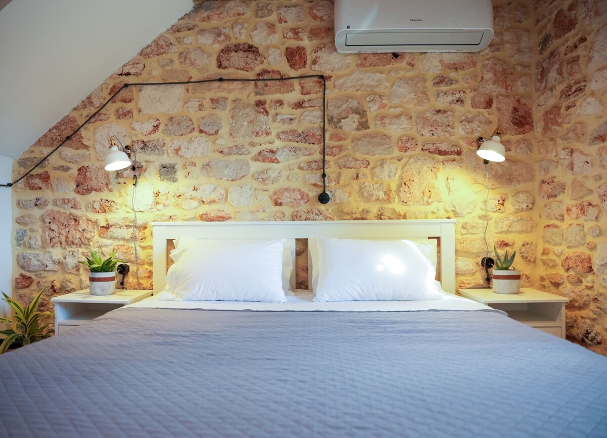 Bedroom with stone walls and warm lighting