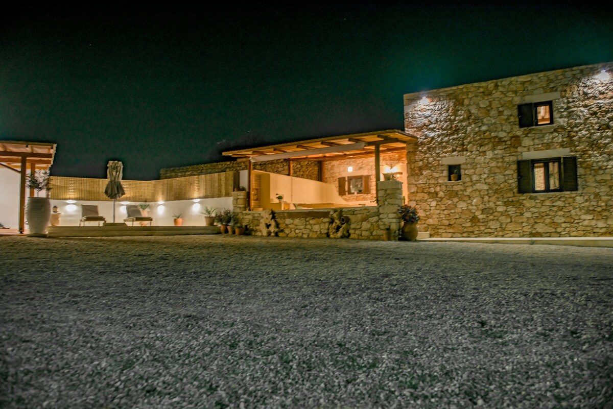 Villa exterior illuminated at night